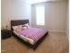 Cozy bedroom with carpet, neutral walls, and a queen-sized bed with colorful bedding at 1520 Village Grove Ct, Hillsborough, NC 27278