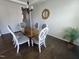 Bright dining room features hardwood floors, glass top dining table and seating for six; perfect for entertaining at 1520 Village Grove Ct, Hillsborough, NC 27278