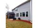 Spacious home exterior featuring gray siding, complemented by a screened porch and well-maintained landscaping at 1520 Village Grove Ct, Hillsborough, NC 27278