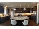 Spacious kitchen with stainless steel appliances, dark wood cabinets, granite countertops and island with seating at 1520 Village Grove Ct, Hillsborough, NC 27278