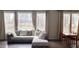 Bright and spacious living area showcasing a comfortable sofa, hardwood floors and large windows at 1520 Village Grove Ct, Hillsborough, NC 27278