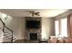Inviting living room featuring a stone fireplace, staircase and hardwood flooring at 1520 Village Grove Ct, Hillsborough, NC 27278