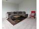 Comfortable living room with plush sofa and area rug at 1520 Village Grove Ct, Hillsborough, NC 27278