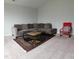 Living room features a gray sectional sofa, area rug, and carpet at 1520 Village Grove Ct, Hillsborough, NC 27278