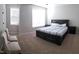 Serene main bedroom with a comfortable bed, side tables, sitting area, and lots of natural light at 1520 Village Grove Ct, Hillsborough, NC 27278