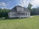A screened porch extends from the back of this two story home, with a beautifully manicured lawn at 165 Cotton Fields Ln # 25, Fuquay Varina, NC 27526
