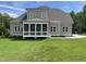 Back exterior view showcasing a screened porch and manicured lawn creating an outdoor oasis at 165 Cotton Fields Ln # 25, Fuquay Varina, NC 27526
