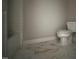 A bathroom features white marble floors, white walls, and a toilet at 165 Cotton Fields Ln # 25, Fuquay Varina, NC 27526