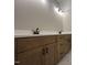 Bathroom with a double vanity, light wood cabinets, matte black fixtures, and a stone countertop at 165 Cotton Fields Ln # 25, Fuquay Varina, NC 27526
