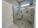 Modern bathroom with glass enclosed shower featuring pebble flooring, seating, and dual shower heads at 165 Cotton Fields Ln # 25, Fuquay Varina, NC 27526