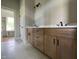 Bathroom featuring double sink vanity with white countertop, shaker cabinets, and neutral tile floors at 165 Cotton Fields Ln # 25, Fuquay Varina, NC 27526