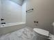 Elegant bathroom features a tub with subway tile surround and marble-look flooring at 165 Cotton Fields Ln # 25, Fuquay Varina, NC 27526