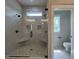 New bathroom features a dual head shower with stone tile flooring and integrated shower seats at 165 Cotton Fields Ln # 25, Fuquay Varina, NC 27526