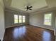 Spacious primary bedroom with tray ceiling and large windows provide a bright and welcoming atmosphere at 165 Cotton Fields Ln # 25, Fuquay Varina, NC 27526