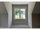 Bright bedroom featuring a large window with white trim and neutral carpeting at 165 Cotton Fields Ln # 25, Fuquay Varina, NC 27526