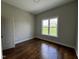 Bright, airy bedroom with hardwood floors and large window offering views of the front yard at 165 Cotton Fields Ln # 25, Fuquay Varina, NC 27526