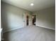 This bedroom has neutral carpeted floors and a view of the entryway and closet at 165 Cotton Fields Ln # 25, Fuquay Varina, NC 27526