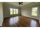 Spacious bedroom with hardwood floors, tray ceiling and ample natural light from large windows at 165 Cotton Fields Ln # 25, Fuquay Varina, NC 27526