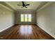 Large bedroom featuring hardwood floors, a ceiling fan, tray ceiling and windows at 165 Cotton Fields Ln # 25, Fuquay Varina, NC 27526