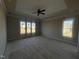 Bedroom with tray ceiling, fan, and large windows offering natural light at 165 Cotton Fields Ln # 25, Fuquay Varina, NC 27526