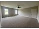 Bedroom with neutral walls, two windows, and a ceiling fan creating a relaxing atmosphere at 165 Cotton Fields Ln # 25, Fuquay Varina, NC 27526