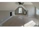 A new bedroom has a ceiling fan, gray walls, built-in shelving, and natural light at 165 Cotton Fields Ln # 25, Fuquay Varina, NC 27526