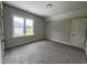 This spacious bedroom features a neutral color palette, carpet flooring, and a bright window at 165 Cotton Fields Ln # 25, Fuquay Varina, NC 27526