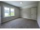 Cozy bedroom with a neutral color scheme, plush carpet, and natural light from the window at 165 Cotton Fields Ln # 25, Fuquay Varina, NC 27526