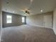 Large bonus room with neutral carpet, natural light, and ceiling fan at 165 Cotton Fields Ln # 25, Fuquay Varina, NC 27526