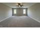 Expansive bonus room with plush carpet, ceiling fan, and plenty of natural light at 165 Cotton Fields Ln # 25, Fuquay Varina, NC 27526