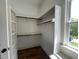Walk-in closet with white shelves, built-in storage and a window at 165 Cotton Fields Ln # 25, Fuquay Varina, NC 27526