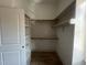 Well-organized closet featuring built-in shelving and hanging rods, enhancing storage efficiency at 165 Cotton Fields Ln # 25, Fuquay Varina, NC 27526