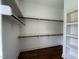 Walk-in closet with white shelving and wood rods at 165 Cotton Fields Ln # 25, Fuquay Varina, NC 27526
