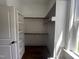 Bright walk-in closet with shelving, rods, and wood floors at 165 Cotton Fields Ln # 25, Fuquay Varina, NC 27526