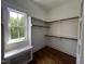 Spacious walk-in closet with built in bench seating under window and wood floors at 165 Cotton Fields Ln # 25, Fuquay Varina, NC 27526