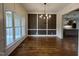 A beautifully staged dining room with hardwood floors, large windows, and a decorative chandelier at 165 Cotton Fields Ln # 25, Fuquay Varina, NC 27526
