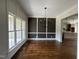 Dining room with hardwood floors, and wainscoting, illuminated by a modern chandelier, adjacent to kitchen at 165 Cotton Fields Ln # 25, Fuquay Varina, NC 27526