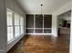 Dining room featuring hardwood floors, wainscoting detail, and a modern chandelier at 165 Cotton Fields Ln # 25, Fuquay Varina, NC 27526