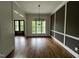 Dining room featuring hardwood floors, wainscoting detail, and a modern chandelier at 165 Cotton Fields Ln # 25, Fuquay Varina, NC 27526