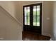 A welcoming entryway featuring elegant double doors with glass panels and hardwood floors at 165 Cotton Fields Ln # 25, Fuquay Varina, NC 27526