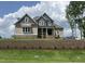 Beautiful two-story home with gray and brown siding, brick foundation, and manicured lawn at 165 Cotton Fields Ln # 25, Fuquay Varina, NC 27526