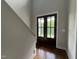 Interior view of a dark wood double door with glass panes and natural light in a foyer at 165 Cotton Fields Ln # 25, Fuquay Varina, NC 27526