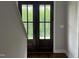 Interior view of a dark wood double door with glass panes and natural light at 165 Cotton Fields Ln # 25, Fuquay Varina, NC 27526