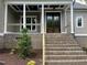 Inviting front porch with double doors, brick steps, and white columns showcasing architectural details at 165 Cotton Fields Ln # 25, Fuquay Varina, NC 27526
