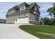 Attached garage with a wide driveway and modern siding, complemented by a well-maintained lawn at 165 Cotton Fields Ln # 25, Fuquay Varina, NC 27526