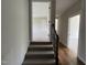 Inviting hallway showcasing hardwood floors and stairs leading to a carpeted room at 165 Cotton Fields Ln # 25, Fuquay Varina, NC 27526
