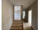Hallway with wood stairs and floors leads to other rooms at 165 Cotton Fields Ln # 25, Fuquay Varina, NC 27526
