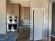Kitchen features wooden cabinets, stainless steel appliances and a pantry at 165 Cotton Fields Ln # 25, Fuquay Varina, NC 27526