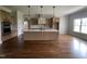 Modern kitchen with wood cabinets, stainless appliances, central island with white countertop and hardwood floors at 165 Cotton Fields Ln # 25, Fuquay Varina, NC 27526