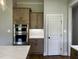 A gourmet kitchen area with modern double ovens, custom cabinets and a decorative backsplash at 165 Cotton Fields Ln # 25, Fuquay Varina, NC 27526